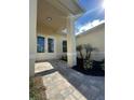 Welcoming entryway with a stone walkway, manicured garden beds, and a covered porch leading to double doors at 8136 Sweden Blvd, Punta Gorda, FL 33982