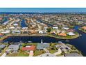 Captivating aerial view of a waterfront home with canal access in a vibrant residential community at 1206 Winward Ct, Punta Gorda, FL 33950