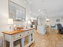Open-concept living space featuring a kitchen island, modern countertops, and an inviting dining area at 15288 Mille Fiore Blvd, Port Charlotte, FL 33953