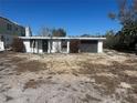 Image shows the home's exterior with a garage and the surrounding landscaping at 2061 S Pine St, Englewood, FL 34224