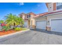 Well-maintained townhome exterior featuring a driveway, landscaping, stucco finish, and a terracotta roof at 240 W End Dr # 312, Punta Gorda, FL 33950