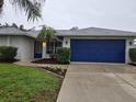 Charming home with a well-kept lawn, landscaped flower beds, and a two-car garage at 3753 Aba Ln, North Port, FL 34287