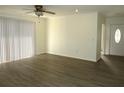 Open living room with hardwood floors and large sliding glass doors for natural light at 409 Ricold Ter, Port Charlotte, FL 33954