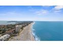 Expansive oceanfront views stretch along the sandy beach, showcasing the condo's desirable coastal location at 600 Sutton Pl # 101B, Longboat Key, FL 34228