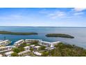 Scenic aerial view showcases a tranquil waterfront community with lush greenery and stunning ocean views at 600 Sutton Pl # 101B, Longboat Key, FL 34228