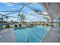 Enjoy the refreshing enclosed pool with views of the canal and the outdoors at 955 Don Juan Ct, Punta Gorda, FL 33950