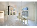 Elegant dining room with a glass table, chandelier, and bright natural light at 1065 Harbour Glen Pl, Punta Gorda, FL 33983
