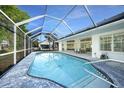 A refreshing screened-in pool area with ample seating, perfect for relaxation and entertaining at 1065 Harbour Glen Pl, Punta Gorda, FL 33983