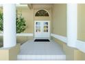 Elegant front entrance with classic double doors, white tile flooring, and grand columns for a welcoming feel at 1311 Pine Siskin Dr, Punta Gorda, FL 33950