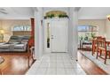 Inviting foyer with tile flooring, leading to living and dining areas with warm wood flooring at 1848 Birmingham Blvd, Port Charlotte, FL 33980