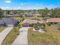 Aerial shot of a cozy single-story home with a long driveway and a well-maintained yard in a quiet neighborhood at 2333 Rio De Janeiro Ave, Punta Gorda, FL 33983