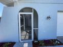 Close-up of arched doorway with decorative flowers, leading into a bright and inviting home interior at 234 Shadow Nw St, Port Charlotte, FL 33952