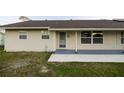 Inviting front entrance with a covered porch, featuring modern paint and landscaping at 536 Lakehurst Nw Ave, Port Charlotte, FL 33952