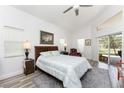 Serene main bedroom with a comfortable bed, wood-look floors, and plenty of natural light at 619 Boundary Blvd, Rotonda West, FL 33947