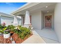 Welcoming front porch with decorative plants and wreath on the front door at 6315 164Th E Ave, Parrish, FL 34219