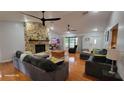 The spacious living area showcases a stone fireplace, hardwood flooring, and a neutral color palette at 131 Spring Lake Nw Blvd, Port Charlotte, FL 33952