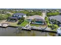 Beautiful home with a screened-in pool on the canal with a private boat dock at 15538 Aqua Cir, Port Charlotte, FL 33981
