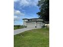 Two-story home with three-car garage and a paver driveway at 22223 Seyburn Ter, Port Charlotte, FL 33954