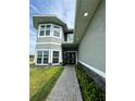 Inviting front entrance with stone accents, double doors, and manicured landscaping at 22223 Seyburn Ter, Port Charlotte, FL 33954