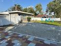 Charming home featuring a well-maintained front yard with chairs and a gravel drive at 23442 Harper Ave, Punta Gorda, FL 33980