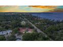 Scenic aerial view of the home's location near a beautiful bay, enhanced by lush surroundings at sunset at 27475 Cleveland Ave, Punta Gorda, FL 33982