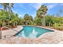 Relaxing pool surrounded by lush landscaping with tropical palms, providing a private and serene outdoor oasis at 27475 Cleveland Ave, Punta Gorda, FL 33982