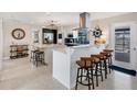 Spacious kitchen with stainless appliances, granite countertops, and bar seating with stylish stools at 280 Belvedere Ct, Punta Gorda, FL 33950