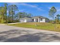 Charming single-story home features a two-car garage and a well-manicured lawn at 3297 Swanee Rd, Punta Gorda, FL 33980