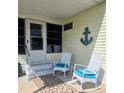 Inviting porch with comfortable rocking chairs, decorative anchor, and a welcoming entrance at 354 Blackburn Blvd, North Port, FL 34287