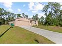 Front exterior of a cozy single-story house with a driveway and neatly trimmed lawn at 401 Calendar St, Port Charlotte, FL 33954