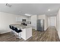 Bright kitchen with white cabinetry, stainless steel appliances, and granite countertops at 401 Calendar St, Port Charlotte, FL 33954