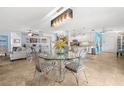 Bright living area with tile floors, decorative lighting, and seamless flow into the adjacent kitchen at 4168 Harbor Blvd, Port Charlotte, FL 33952