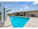 Enjoy the outdoors with this in-ground pool within a screened enclosure, offering shade and a relaxing space at 4168 Harbor Blvd, Port Charlotte, FL 33952