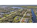 Scenic aerial view of a waterfront community featuring canals and lush greenery at 4420 Larkspur Ct, Port Charlotte, FL 33948