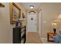 Welcoming foyer featuring a patterned rug, decorative lighting, and tasteful decor at 4420 Larkspur Ct, Port Charlotte, FL 33948