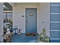 Inviting entryway with blue door, decorative accents, and charming seasonal decorations at 4420 Larkspur Ct, Port Charlotte, FL 33948