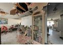 Spacious living room with a view to an adjacent room with some ceiling damage at 490 Via Esplanade, Punta Gorda, FL 33950