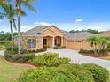Charming home featuring manicured landscaping, a spacious driveway, and a two-car garage, enhancing curb appeal at 624 Planters Manor Way, Bradenton, FL 34212