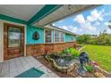 Charming turquoise home featuring a welcoming front porch and an attractive decorative fountain at 1137 Ponderosa Rd, Venice, FL 34293