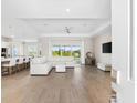 Bright living room with an open floor plan, tile floors, modern lighting, and sliding glass doors to a view at 17336 Sandpearl Rd, Venice, FL 34293