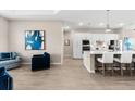 Bright open-concept living area showcasing stylish decor, wood-look flooring, and a modern aesthetic at 17336 Sandpearl Rd, Venice, FL 34293