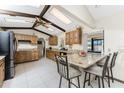 Well-lit kitchen with granite countertops, wooden cabinets, stainless steel appliances, and barstool seating at 18584 Alphonse Cir, Port Charlotte, FL 33948