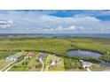 Aerial view of a lovely home near a waterway surrounded by a lush green landscape at 19023 Midway Blvd, Port Charlotte, FL 33948