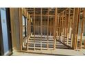 Open-concept new construction with framing in place, featuring concrete walls and expansive windows at 242 Bangsberg Se Rd, Port Charlotte, FL 33952