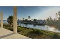 Scenic waterfront view showcasing lush landscaping and the picturesque canal and beautiful homes at 242 Bangsberg Se Rd, Port Charlotte, FL 33952