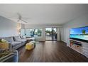 Bright living room featuring hardwood floors, neutral walls, a comfortable sofa, and expansive water view at 25188 Marion Ave # 1033, Punta Gorda, FL 33950