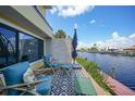 Cozy outdoor patio with comfortable seating and a picturesque view of the waterfront at 25188 Marion Ave # 1033, Punta Gorda, FL 33950