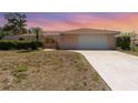 Charming single-story home featuring a tile roof, arched entryway, and a well-manicured lawn at 2621 Via Veneto Dr, Punta Gorda, FL 33950