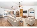 Bright living room with vaulted ceilings, tile floors, and views of the outdoor pool area at 2621 Via Veneto Dr, Punta Gorda, FL 33950