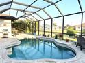 Screened in pool area with in ground pool, brick patio, and view of neighborhood homes at 3414 Sandpiper Dr, Punta Gorda, FL 33950